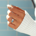 blue heart and pear-cut lab diamond toi et moi wedding ring on model's finger
