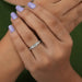 olive emerald cut diamond solitaire accent ring with white gold band on model's finger