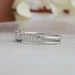 side view of olive emerald-cut diamond solitaire accent ring with white gold band