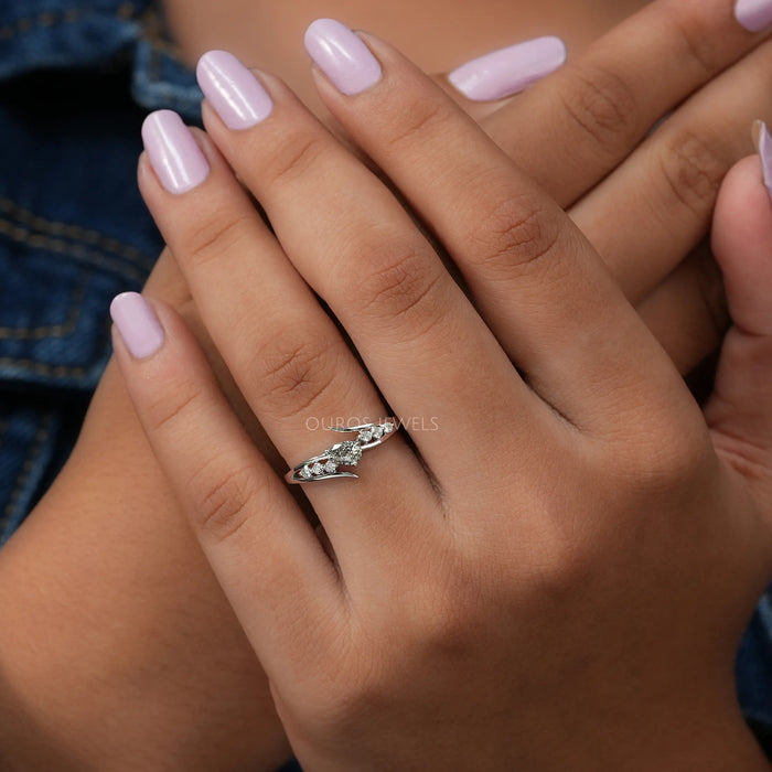 Front view of engagement ring set in bypass, center stone olive pear shape in 14k white gold.