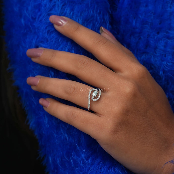 In finger front look of oval shaped diamond engagement ring with bypass setting