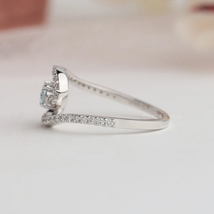 Round stones studded on 14k white gold shank of green oval diamond ring