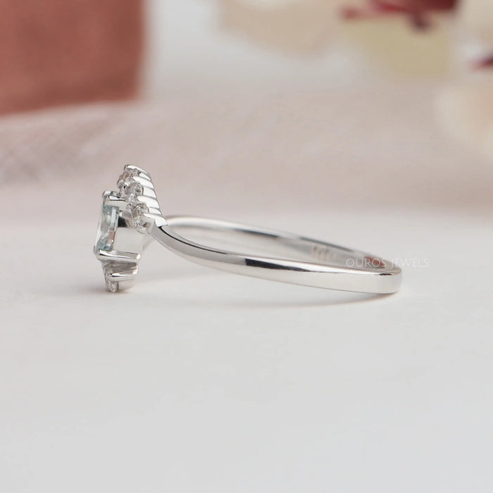 Side view of oval shaped diamond ring with curved band. This engagement ring crafted in 14k white gold & VS clarity. 