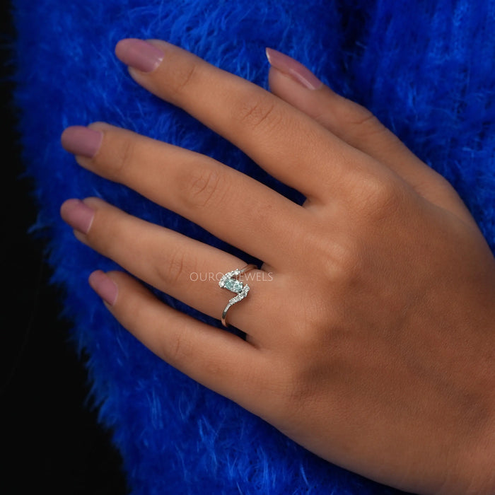 Cross finger view of oval shaped diamond engagement ring in 14k white gold.