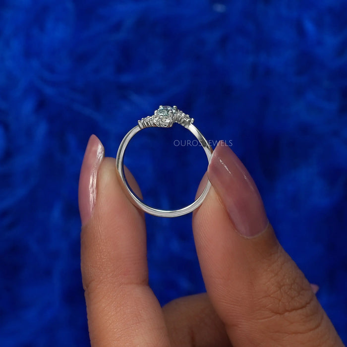 Two finger front view of oval shaped diamond engagement ring set in bypass & VS clarity.