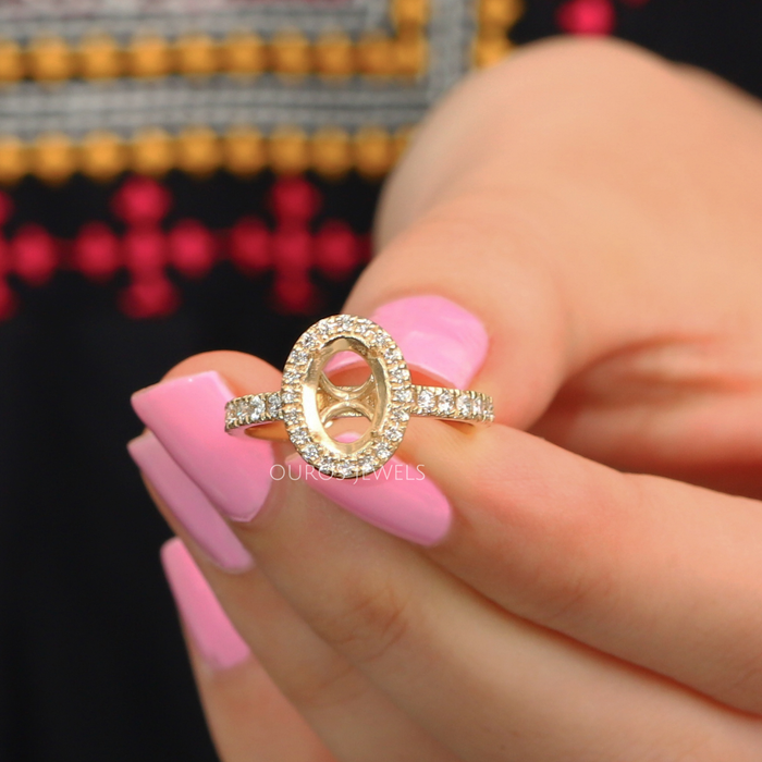close view of oval-shaped round diamond halo semi-mount engagement ring