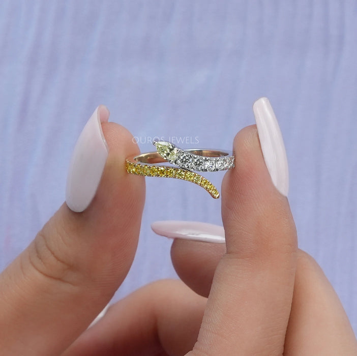 close view of pear and round-cut lab diamond bypass colored wedding band