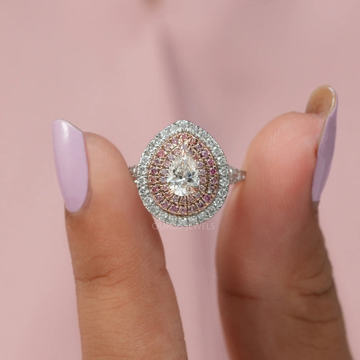 A close up look of Triple halo diamond engagement ring with brilliant pear cut lab created diamond