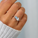 blue princess-cut and pear diamond toi et moi engagement ring on model's finger