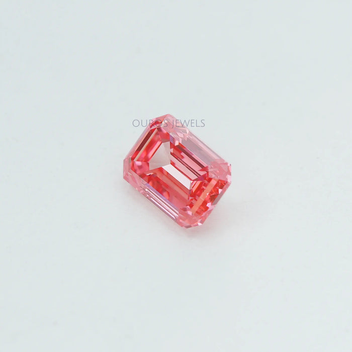 side view of 0.76 ct pink lab made emerald diamond loose on fabric