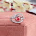 top view of pink heart-cut lab-grown diamond halo wedding ring on jewelry box