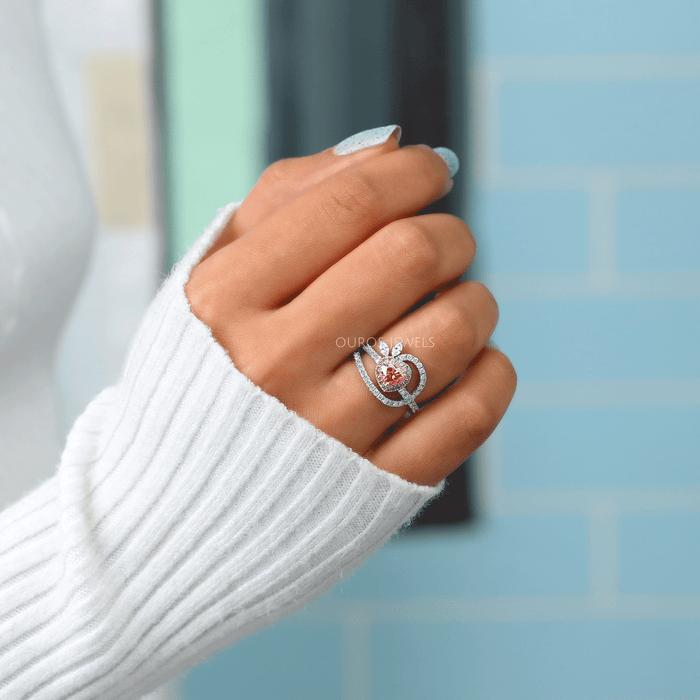 pink heart-cut lab-grown diamond halo wedding ring on model's finger