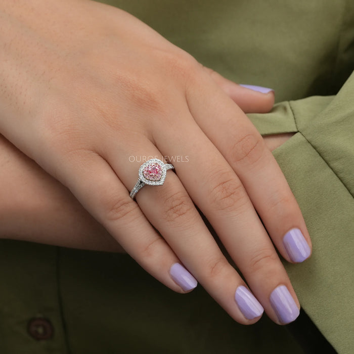 pink heart shaped diamond double halo engagement ring on model's finger