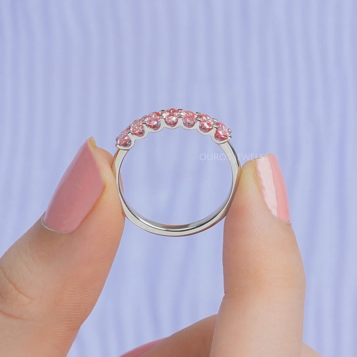close view of pink oval-cut seven stone lab diamond wedding bands