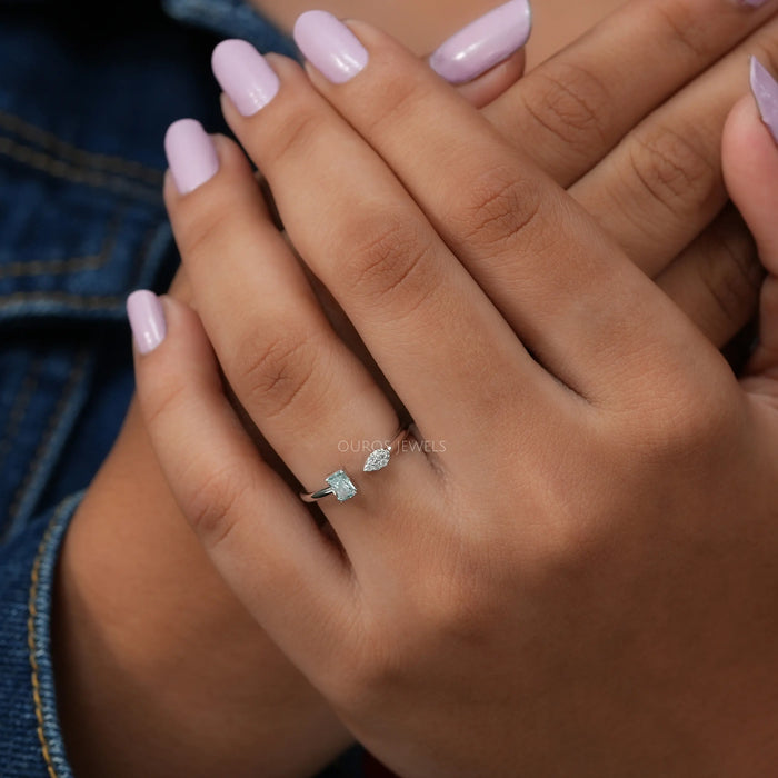 green radiant-cut lab diamond open cuff dainty wedding band on model's finger