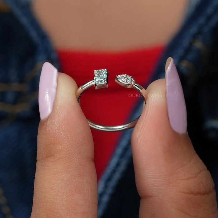 close view of green radiant-cut lab diamond open cuff dainty wedding band