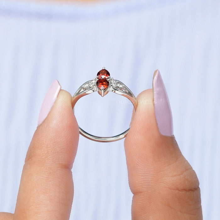close view of red pear-cut lab diamond two-stone dainty colored wedding band