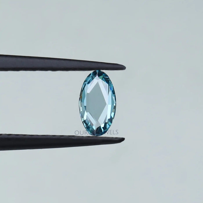 0.53 carat rose cut blue oval shape lab made diamond loose held with tweezer