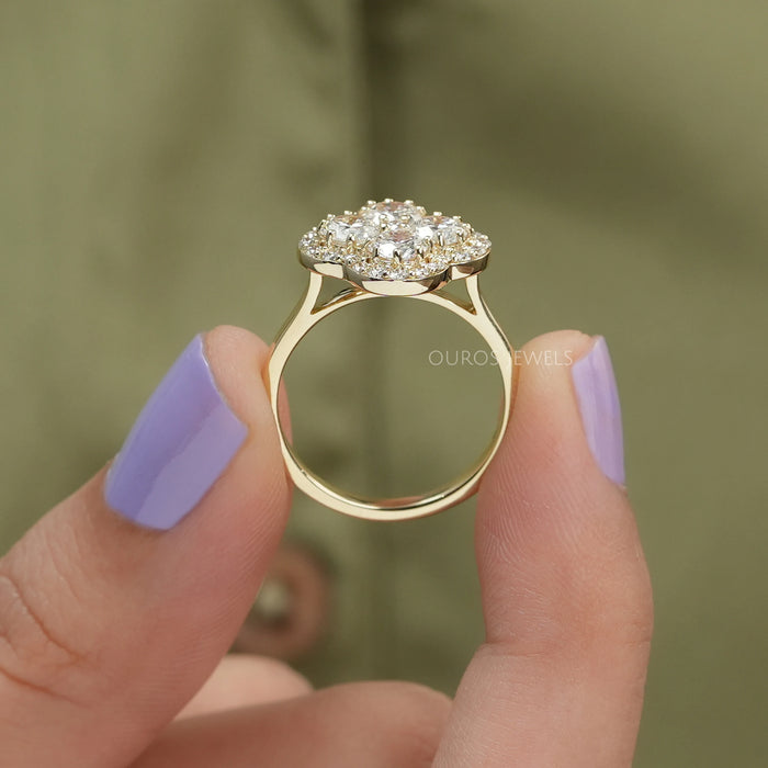 close view of round cut lab diamond floral halo engagement ring yellow gold
