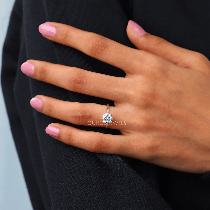 round cut diamond hidden halo solitaire engagement ring gold in finger