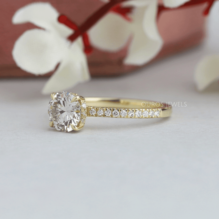 side view of round cut lab diamond solitaire hidden halo engagement ring yellow gold band