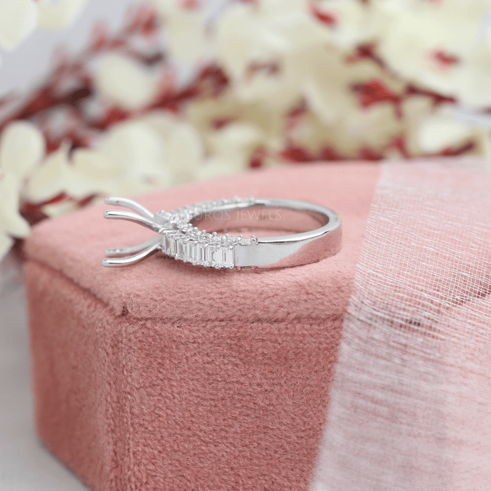 side view of baguette-cut accent diamond semi-mount engagement ring on jewelry box