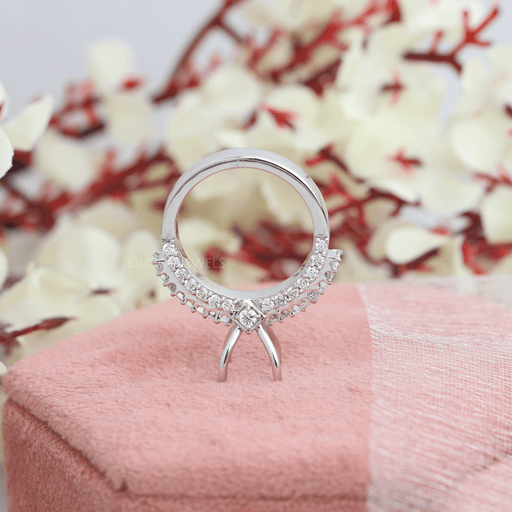 backside fall view of baguette-cut accent diamond semi-mount wedding ring on jewelry box