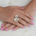 floral-style two-tone round-cut diamond vintage engagement ring on model's finger