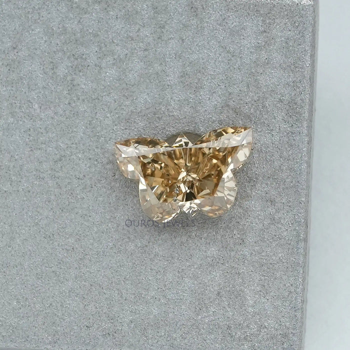 0.4 carat yellow butterfly manufactured diamond on matte material