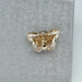 0.4 carat yellow butterfly manufactured diamond on matte material