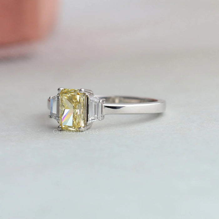 side view of yellow radiant cut lab diamond three stone engagement ring